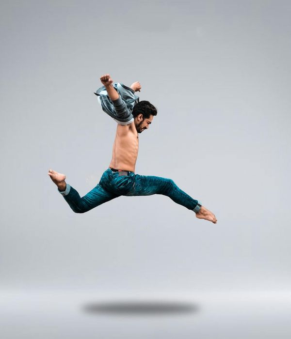 A person in a dynamic pose, showing controlled energy.